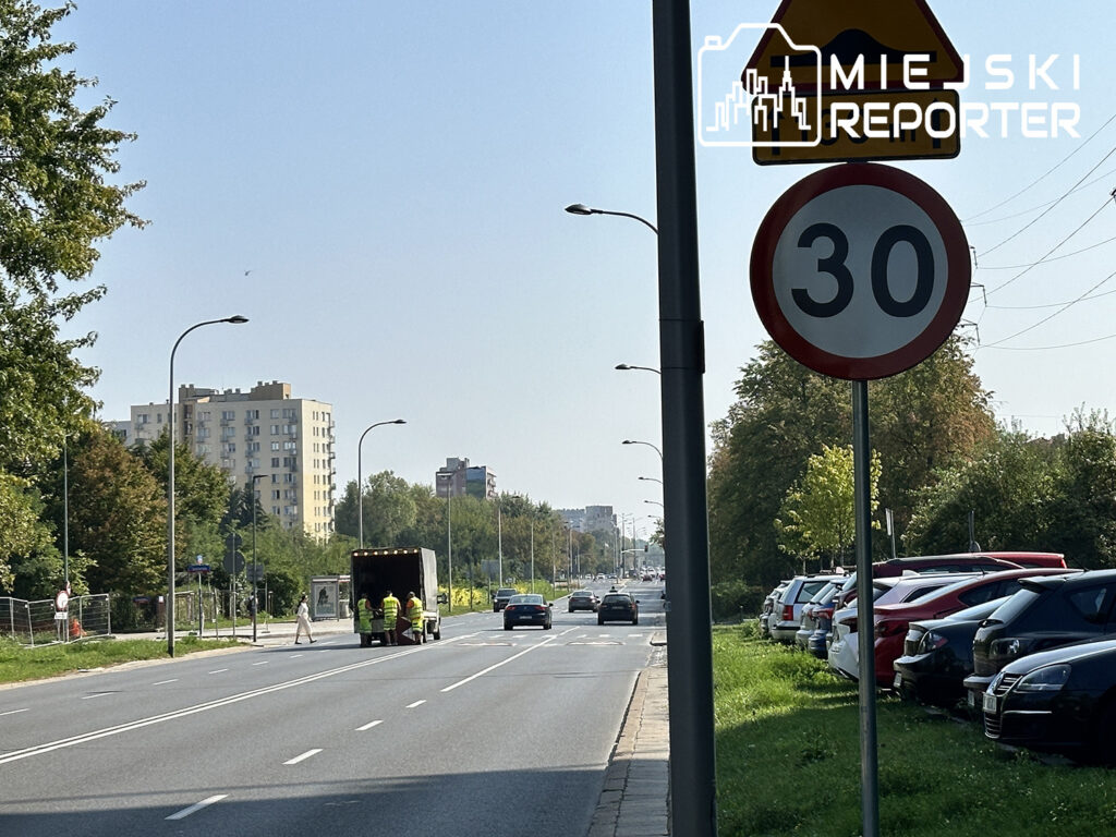 a road with cars and a sign