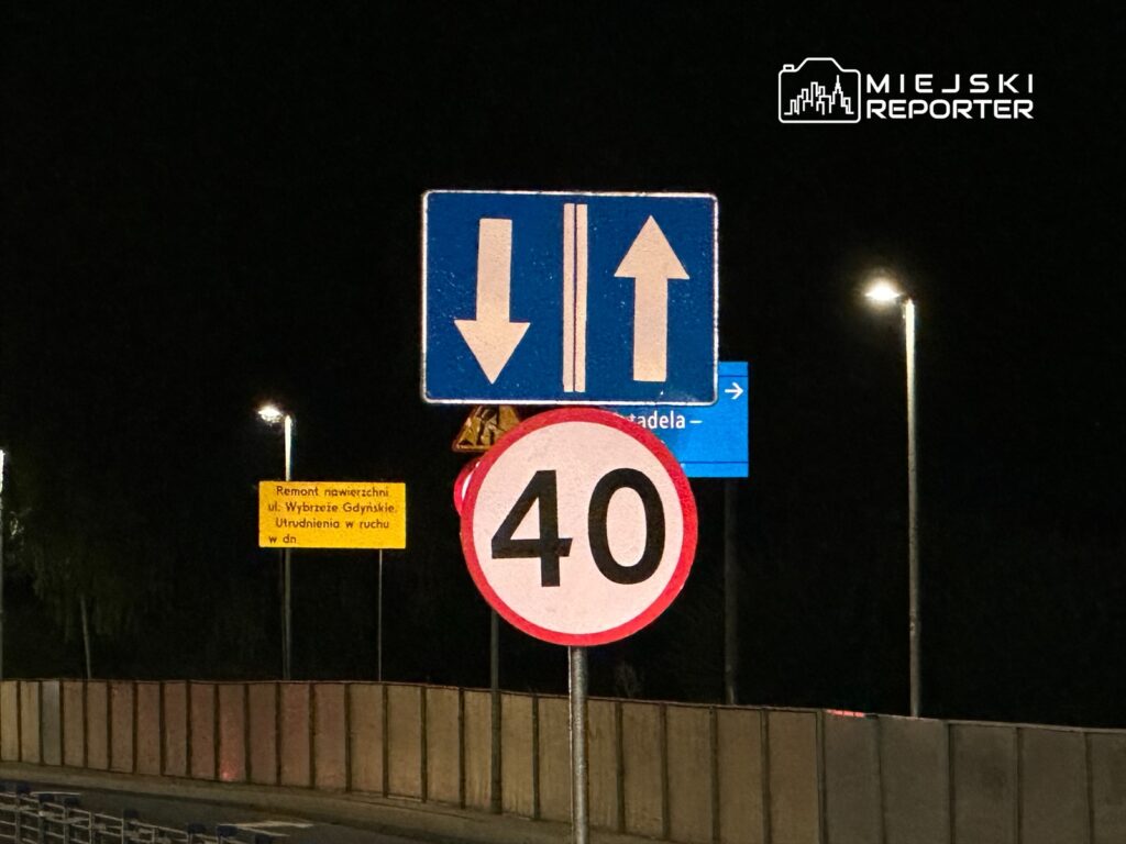Znaki drogowe informujące o ograniczeniu prędkości do 40 km/h oraz kierunku ruchu na drodze w nocy.