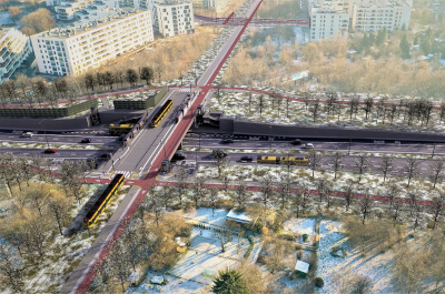 Nowoczesny węzeł komunikacyjny z torami tramwajowymi i jezdniami, otoczony zielenią i budynkami mieszkalnymi.
