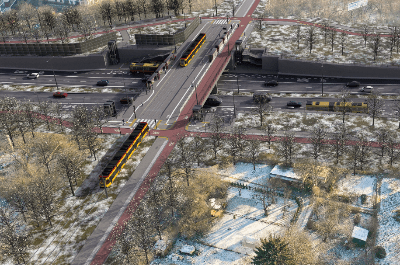 Nowoczesny most tramwajowy z torami, otoczony drzewami i śniegiem, łączy dwie części miasta, z ruchem drogowym poniżej.