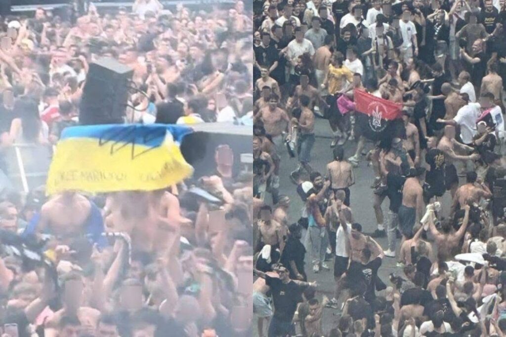 Tłum ludzi na koncercie, niektórzy trzymają flagi, wśród nich widoczna niebiesko-żółta flaga.