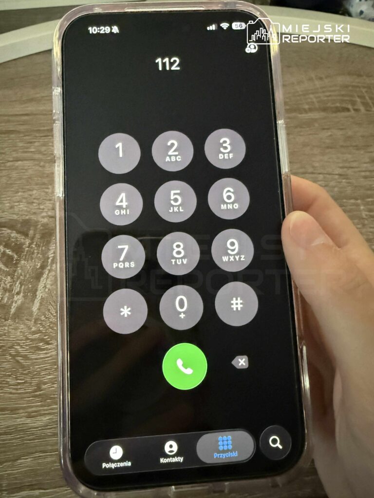 Smartfon z wyświetlaczem włączonym na ekranie dialera, z numerem alarmowym 112.