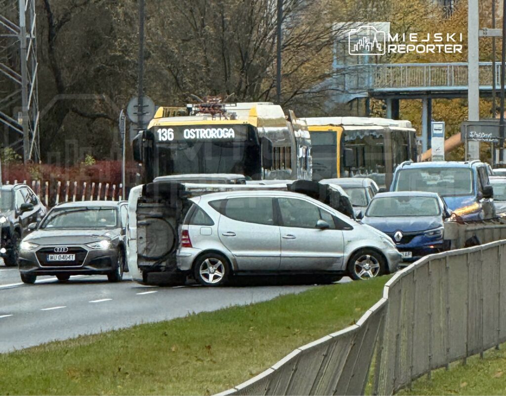 Zablokowany ruch drogowy z powodu uszkodzonego samochodu na jezdni, w tle autobus linii 136.