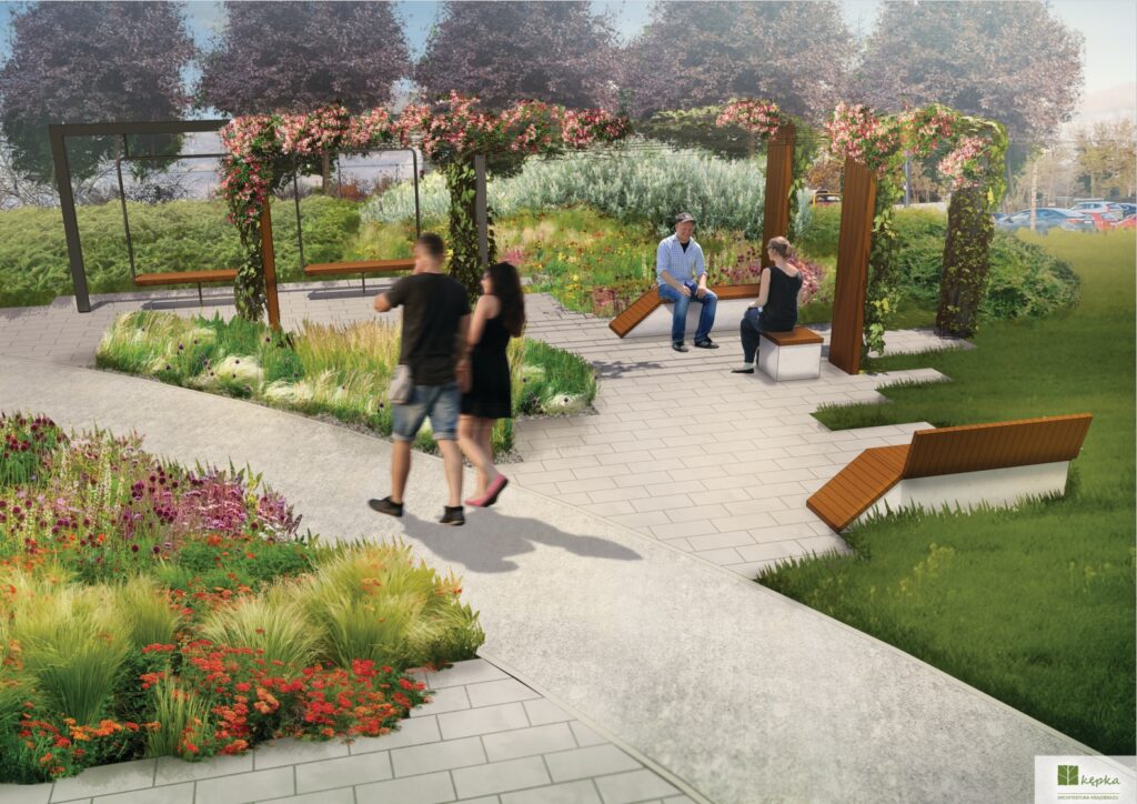 Para spacerująca wśród kwiatów, obok ławek, na nowoczesnej, zaaranżowanej przestrzeni zielonej.