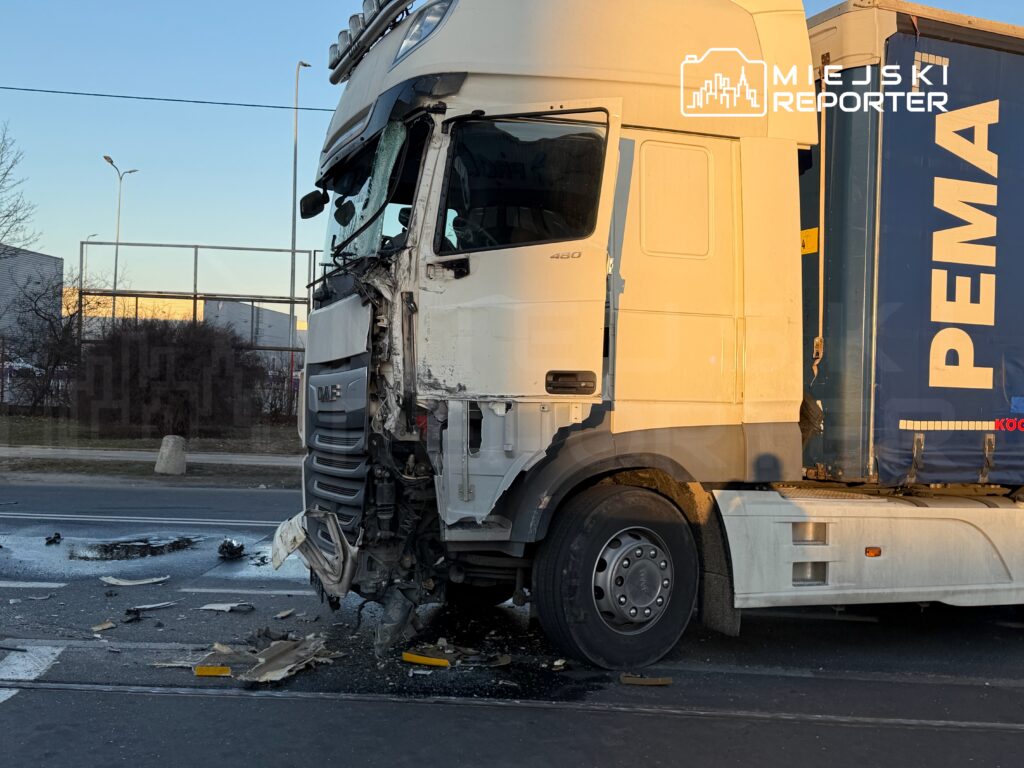 Ciężarówka DAF z uszkodzoną kabiną i zniszczonym przodem stoi na jezdni, wokół porozrzucane fragmenty pojazdu.
