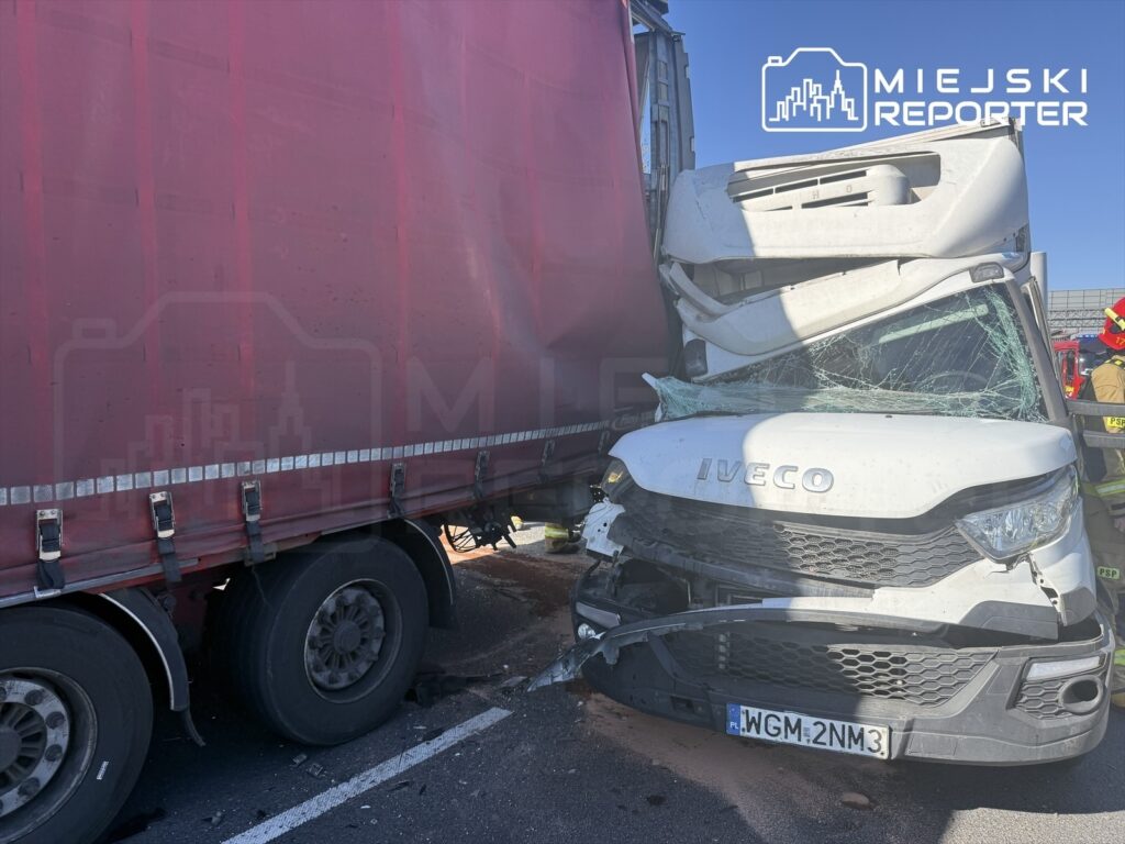 Zderzenie dwóch ciężarówek na drodze, z widocznym uszkodzeniem przodu białego pojazdu marki Iveco.