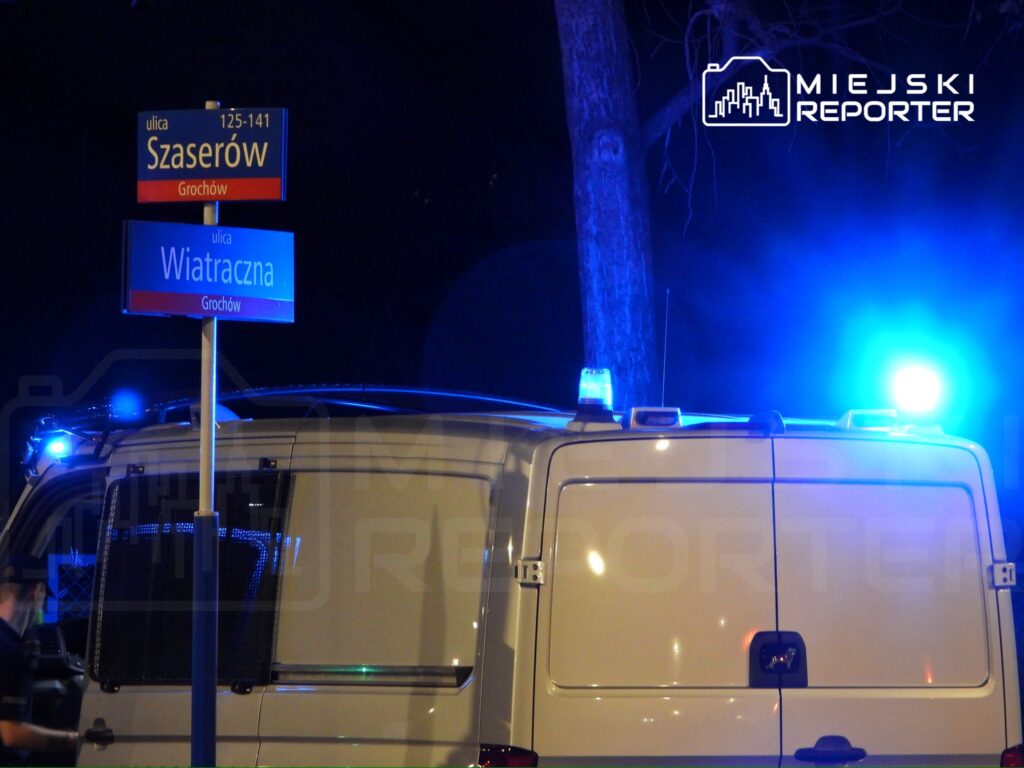 Policyjny samochód z niebieskimi światłami zaparkowany przy skrzyżowaniu ulic Szaserów i Wiatracznej w Grochowie.