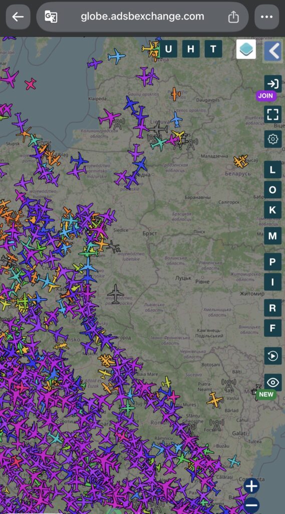 Mapa z dużą ilością samolotów w powietrzu, oznaczonych różnymi kolorami, nad Europą Środkowo-Wschodnią.